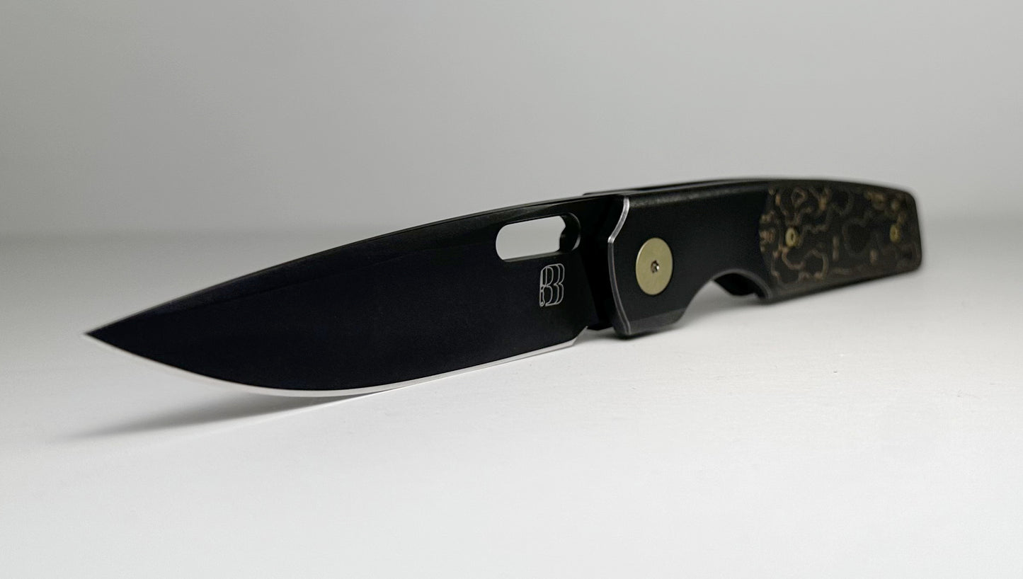 Berg Blades | NRD Sweeney Pre-Owned SN #21/60 - Black PVD CPM-20CV Drop Point Blade - Black 6AL-4V Titanium Handle w/ Gold Camo Fat Carbon Fiber Inlays & Gold Anodized Hardware - Ti Frame Lock w/ Flipper Tab | Made in China by Reate