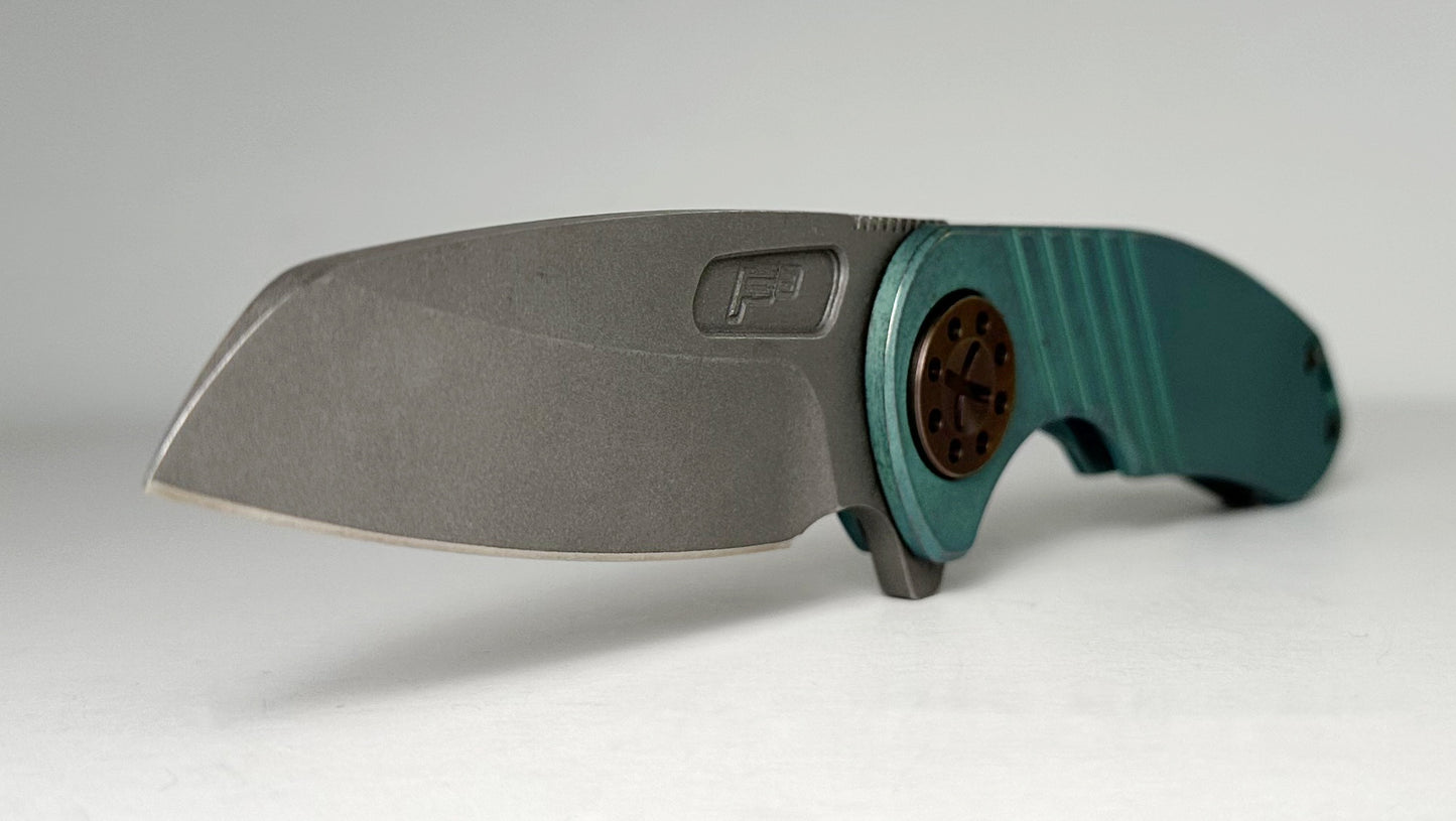 Curtiss Knives Custom F3 Med Wharny Flipper Pre-Owned - Blasted CPM Magnacut Wharncliffe Blade - Antique Green Titanium Slide-Milled Handle Scales w/ Root Beer Hardware - Frame Lock Flipper | Made in USA