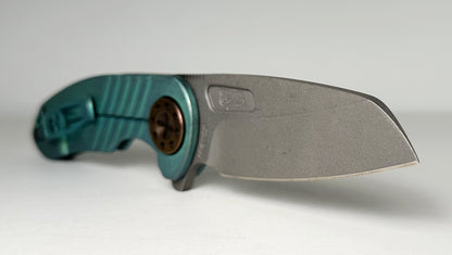 Curtiss Knives Custom F3 Med Wharny Flipper Pre-Owned - Blasted CPM Magnacut Wharncliffe Blade - Antique Green Titanium Slide-Milled Handle Scales w/ Root Beer Hardware - Frame Lock Flipper | Made in USA