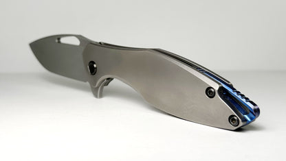 Koenig Arius Gen 2 Frame Lock Flipper Pre-Owned - Stonewash CTS-XHP Drop Point & 3D Contoured Titanium Handle - Blue Backspacer & Black Pivot | Made in USA