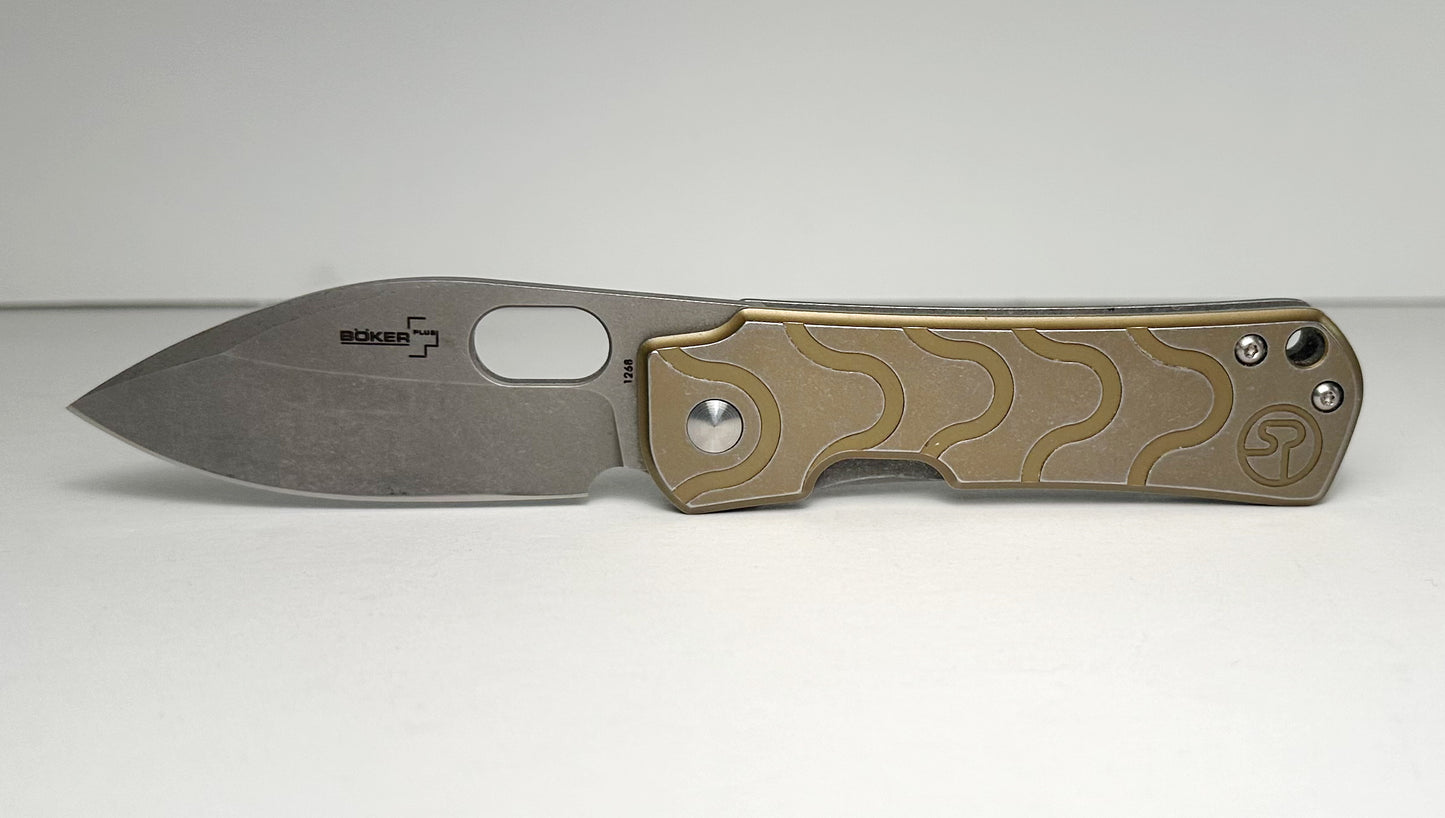 Boker Plus | Serge Panchenko Gust Pre-Owned NO BOX 01BO082 - Stonewash 2.75" CPM-D2 Drop Point Blade & Bronze Finished Stainless Steel Handle - Frame Lock Folder w/ Blade Hole | Made in China